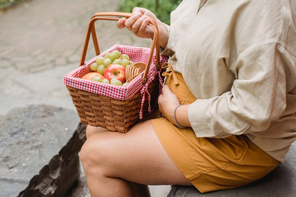 Pregnant woman preparing a healthy nutrient-rich meal to support energy during pregnancy