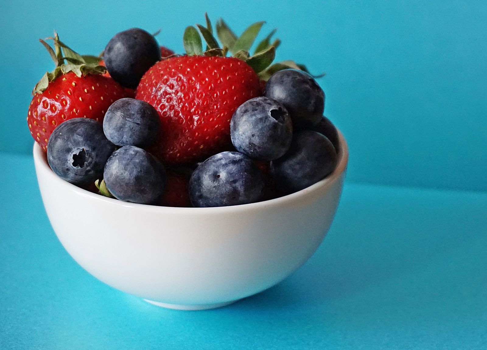 Fresh strawberries providing vitamin C, fiber and plant flavonoids