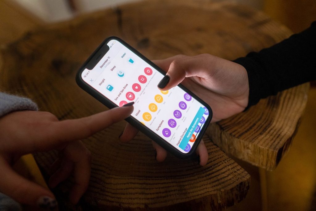 Woman using a wellness and health tracking app on a smartphone