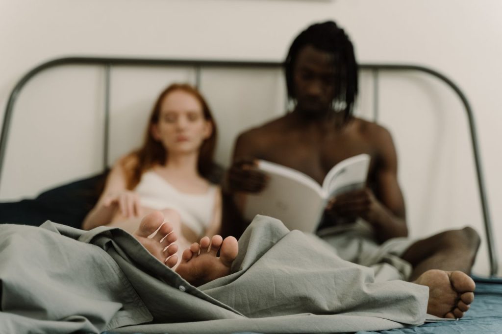 Couple relaxing together in bed and sharing a quiet intimate moment