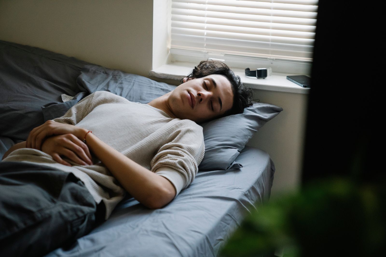Adult man sleeping peacefully in a comfortable bedroom