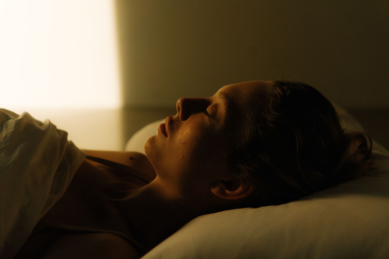 Adult woman sleeping comfortably in bed at night
